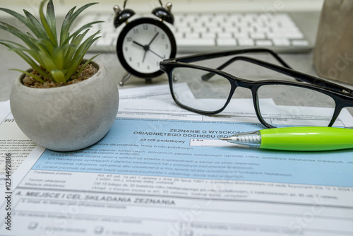 Polish tax form PIT-38, PIT-37 PIT-36L pen calculator glasses on desk. Lump sum recorded on revenues photo