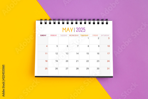 May 2025 Monthly desk calendar for 2025 year on yellow and purple. photo