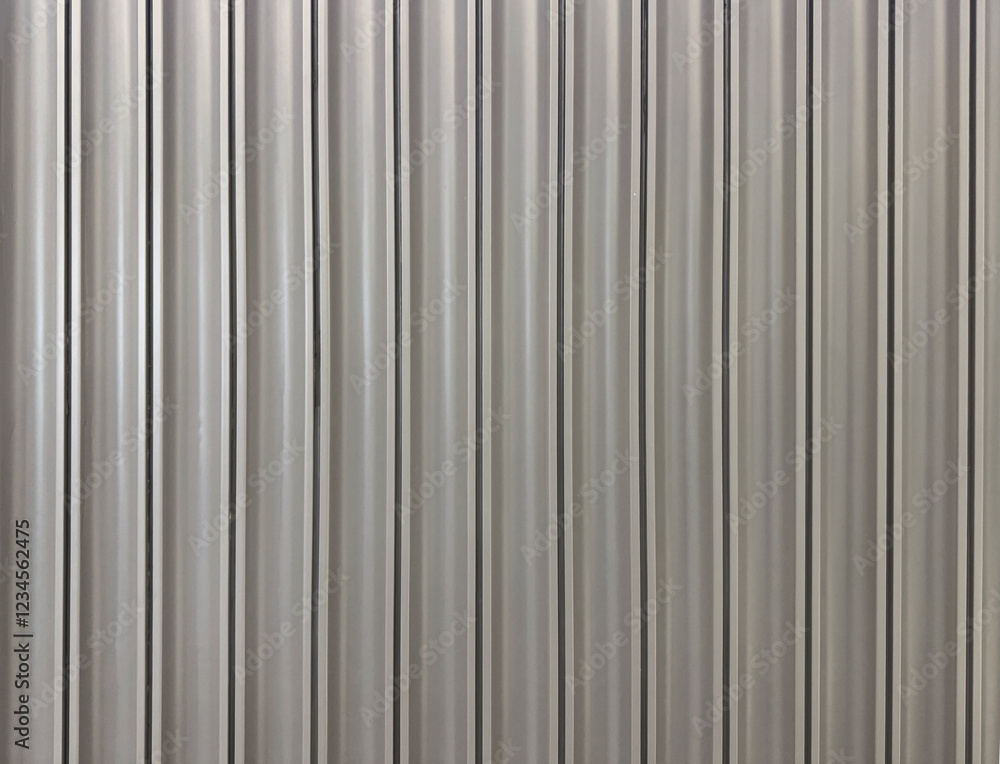 Close up of light grey fluted panel, wood strips or fluted panel strips, in grey paint. Seamless background texture. Close up of light grey fluted panel, wood strips or fluted panel strips, in grey paint. Seamless background texture.