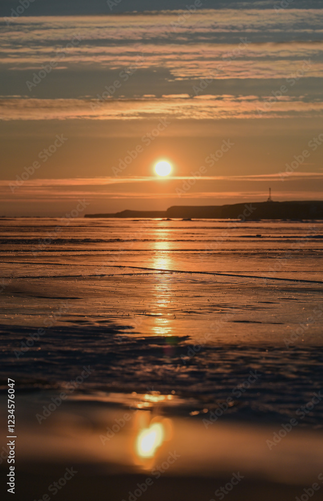 Fototapeta premium sunset over the lake with ice cover