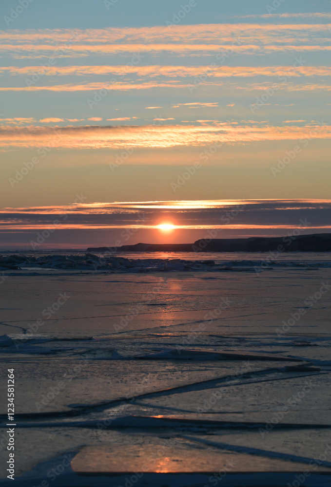 Fototapeta premium sunset over the lake with ice cover