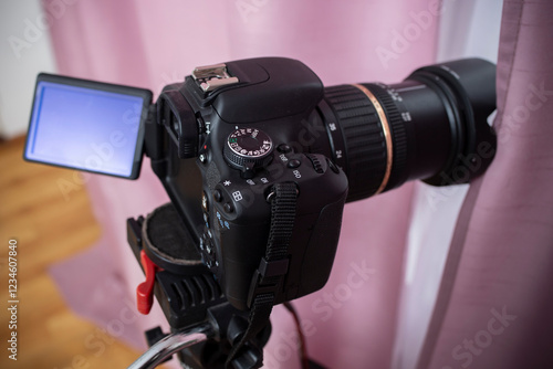 Fotografie Digital video camera hidden behind pink curtains, spying neighbors Peeping