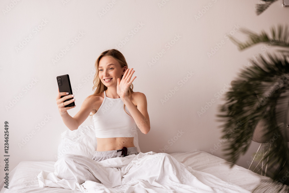 technology and people concept. Caucasian woman with smartphone having video call and waving hand making video in zoom with boyfriend technology and people concept. Caucasian woman with smartphone having video call and waving hand making video in zoom with boyfriend
