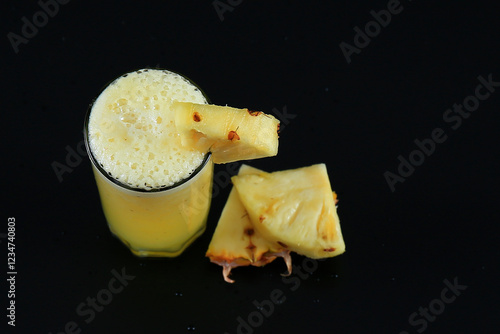 Wallpaper Mural fresh pineapple juice and pineapple pieces on black background Torontodigital.ca
