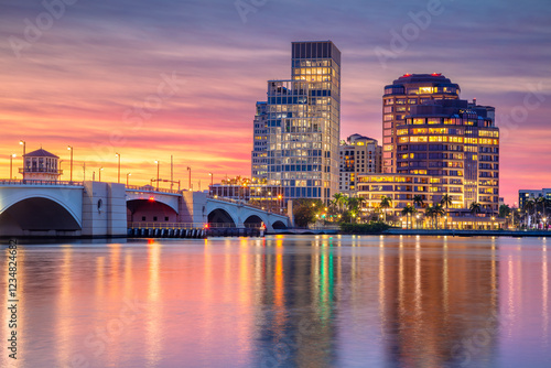 West Palm Beach, Florida, USA. Cityscape image of West Palm Beach, Florida with reflection of the city skyline in the water at beautiful sunset.
