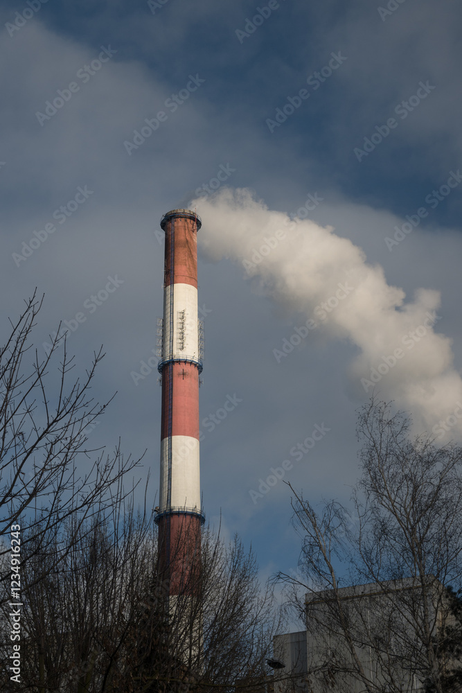 Greenhouse gas emissions into the atmosphere. Smoking power plant chimney, carbon dioxide released into the atmosphere.