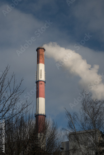Obraz na płótnie Greenhouse gas emissions into the atmosphere. Smoking power plant chimney, carbon dioxide released into the atmosphere.
w salonie