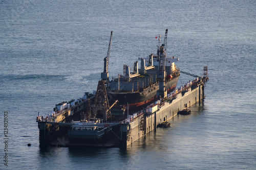 Cargo ship being repaired in a maintenance base at sea