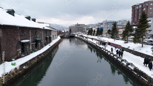 4K Aerial drone footage in Otaru and its famous canal lined by old warehouses in winter in Hokkaido