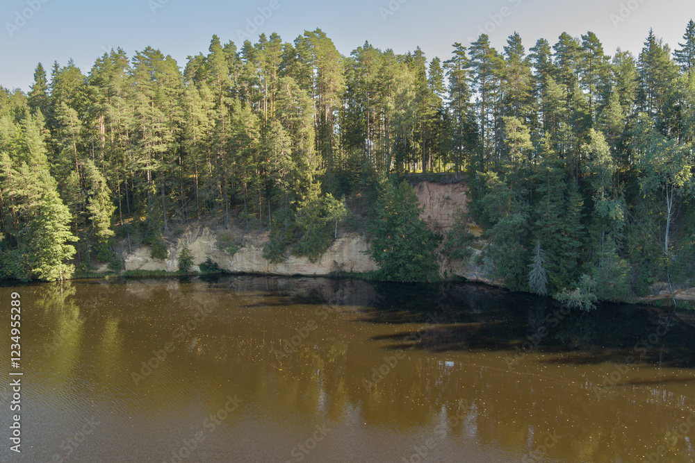 Scenic sandstone cliff over the Ahja River in Taevaskoja: drone aerial photography. Scenic sandstone cliff over the Ahja River in Taevaskoja: drone aerial photography.