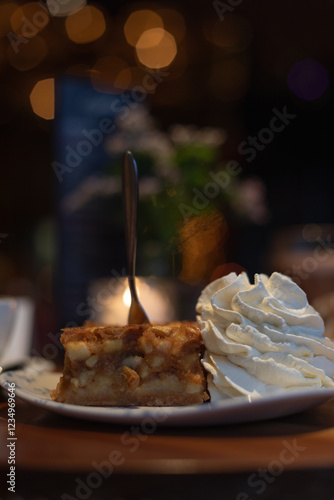 Wallpaper Mural Piece of apple pie with whipped cream on the side, on a table in a restaurant  Torontodigital.ca