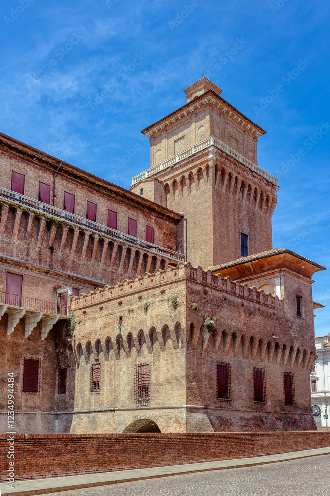 The historic Costello Estense, a medieval defensive structure in Ferrara under clear blue skies