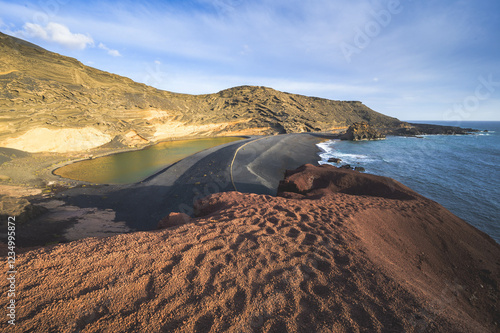 Green lagoon in Lanzarote, in the Gulf area, formed by the crater of a volcano, Canary Islands, Spain photo