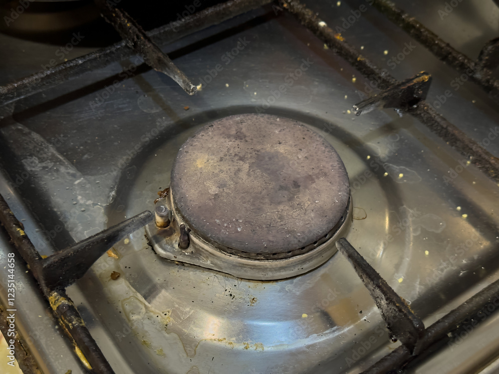 A gas burner with a dirty metal surface, ready for use. A gas burner with a dirty metal surface, ready for use.