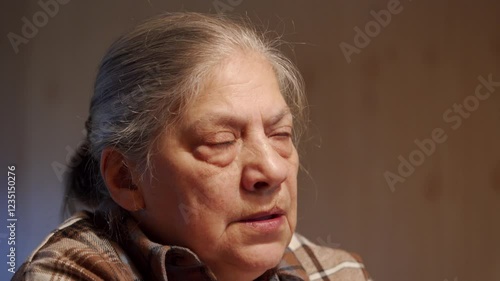 elderly woman, her face etched with wisdom and years, speaks with an earnest gaze. The scene exudes warmth and intimacy, suggesting a heartfelt conversation about life's experiences.