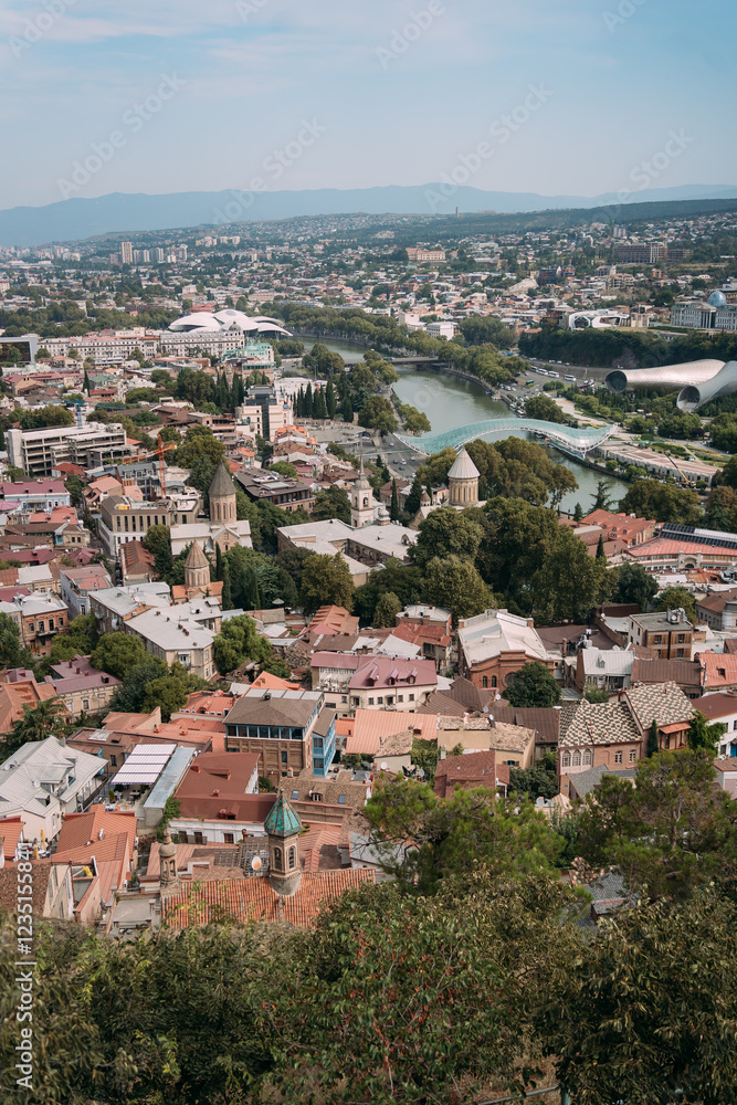 Obraz premium Panoramic view of an old city with historic architecture and modern buildings. Tbilisi, Georgia