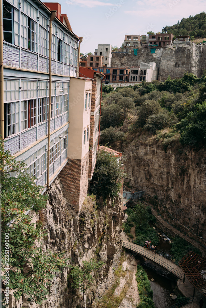 Residential buildings on a cliff. Houses in Tbilisi in the river canyon Residential buildings on a cliff. Houses in Tbilisi in the river canyon