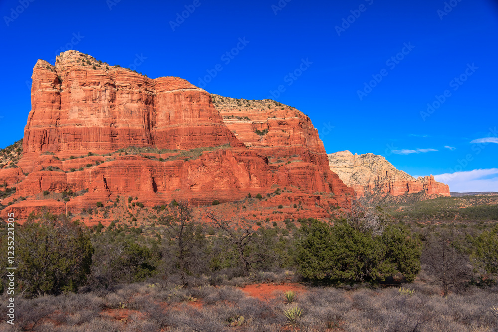 A rocky mountain range with a clear blue sky in the background A rocky mountain range with a clear blue sky in the background