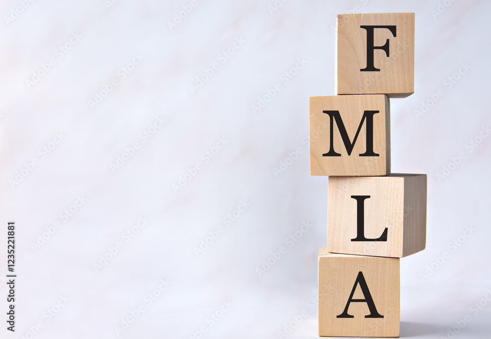 FMLA - acronym on wooden cubes on a white background FMLA - acronym on wooden cubes on a white background