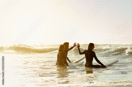 Photography High five, surfer group and friends in sea ready for water sport in the ocean