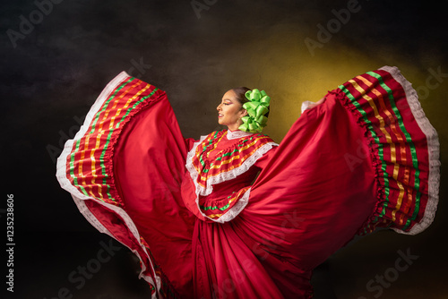 A woman in a red dress is dancing with a green flower in her hair