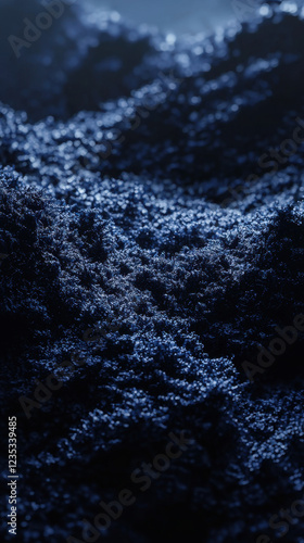 Dark ocean waves with frothy foam in deep blue lighting