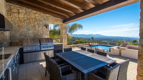 A spacious outdoor kitchen with modern appliances  a grill  and a dining table.