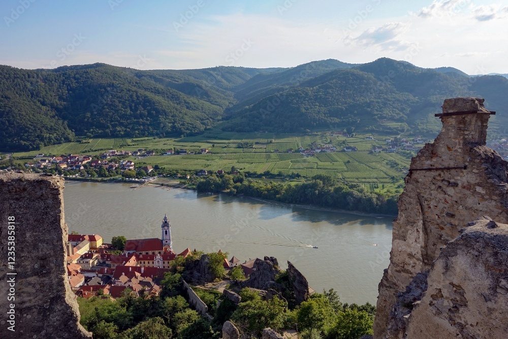 Landscape with castle stone ruins, Durnstein city in Austria at sunset with Danube river and church