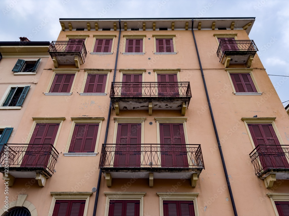 Italian building with closed window shutters, bottom view