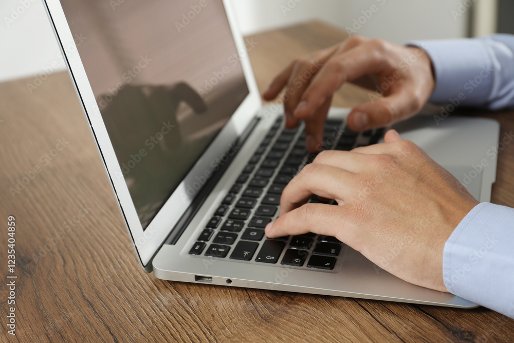 Businessman using laptop at wooden table, closeup. Modern technology Businessman using laptop at wooden table, closeup. Modern technology