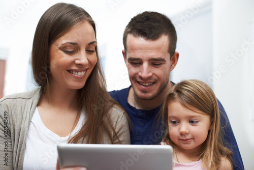 Home, father and mother with girl for tablet, educational video and streaming service for cartoon. House, dad and mom with child for game subscription, ebook or bonding with entertainment application photo