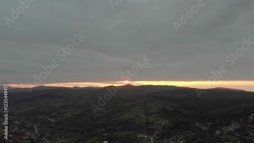 Majestic Mountains, Dense Forest, And Dramatic Clouds Illuminated By A Stunning Sunset. Aerial View Capturing The Breathtaking Beauty Of Nature From A Bird’s-Eye Perspective.