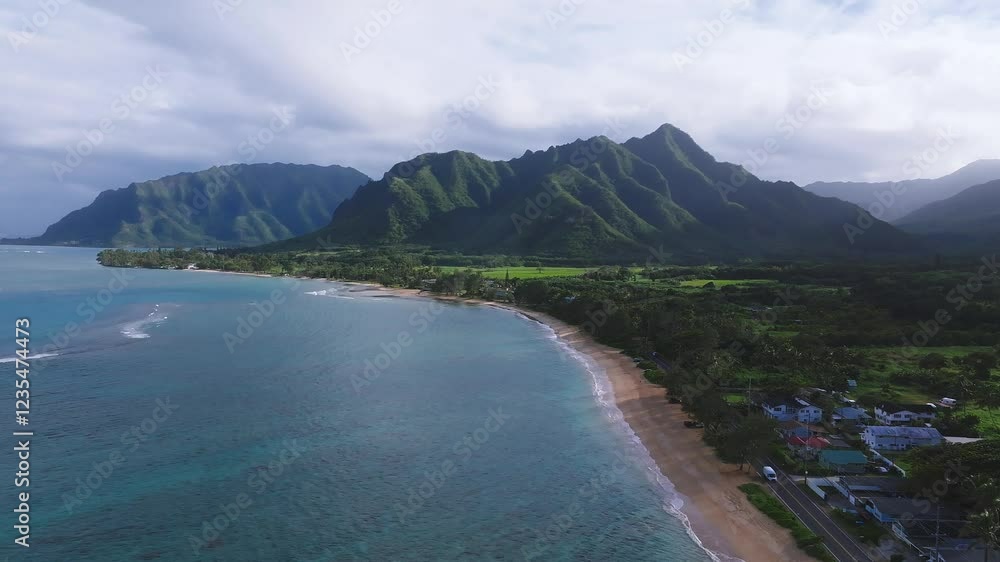 Aerial view of Oahu, Hawaii, showing turquoise waters, sandy beach, and the lush Ko olau mountain range in a smooth, sweeping motion. Aerial view of Oahu, Hawaii, showing turquoise waters, sandy beach, and the lush Ko olau mountain range in a smooth, sweeping motion.