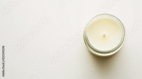 single white wax candle in clear glass jar on white background  minimalist home decor  relaxing spa atmosphere  luxury lifestyle products  relaxation  peace and tranquility  fragra photo