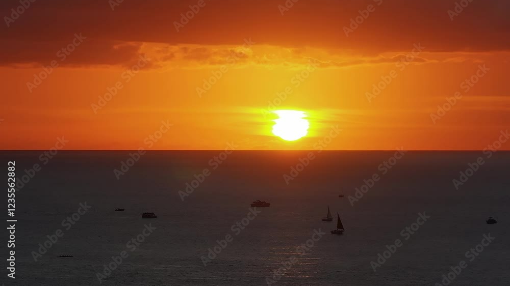 Sunset over the ocean near Oahu, Hawaii, with vibrant hues reflecting on the water. Sailboats gently move across the calm sea, creating a serene scene. Sunset over the ocean near Oahu, Hawaii, with vibrant hues reflecting on the water. Sailboats gently move across the calm sea, creating a serene scene.
