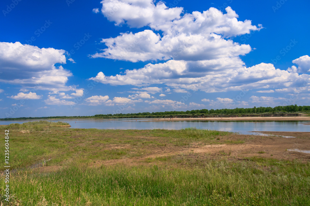 A beautiful blue sky with a few clouds and a large body of water A beautiful blue sky with a few clouds and a large body of water
