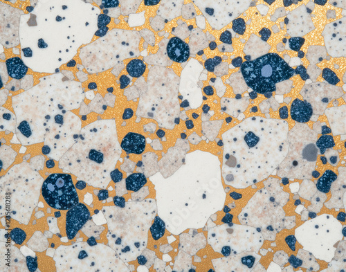 Seamless terrazzo marble composite with gold flecks and crushed sapphire chips, epoxy resin binder texture for industrial floor tiling. photo