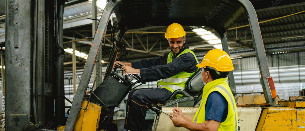 Fototapeta premium Two men in yellow safety vests are in a forklift cab