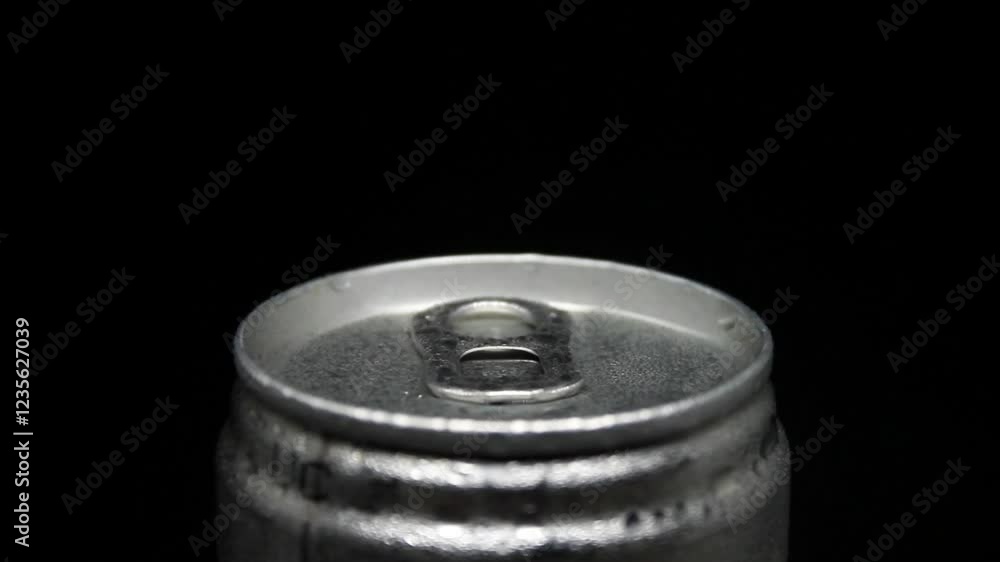 cold aluminum can spinning against a black background. Water droplets cover the metallic surface, creating a refreshing effect. Perfect for beverage ads, branding, or motion graphics. cold aluminum can spinning against a black background. Water droplets cover the metallic surface, creating a refreshing effect. Perfect for beverage ads, branding, or motion graphics.
