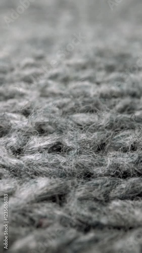 Extreme detail view of sheep wool cloth texture in macro dolly shot. Flowing animal fiber material for handcraft knitting. Textile abstract background. Winter fashion clothing industry concept. photo