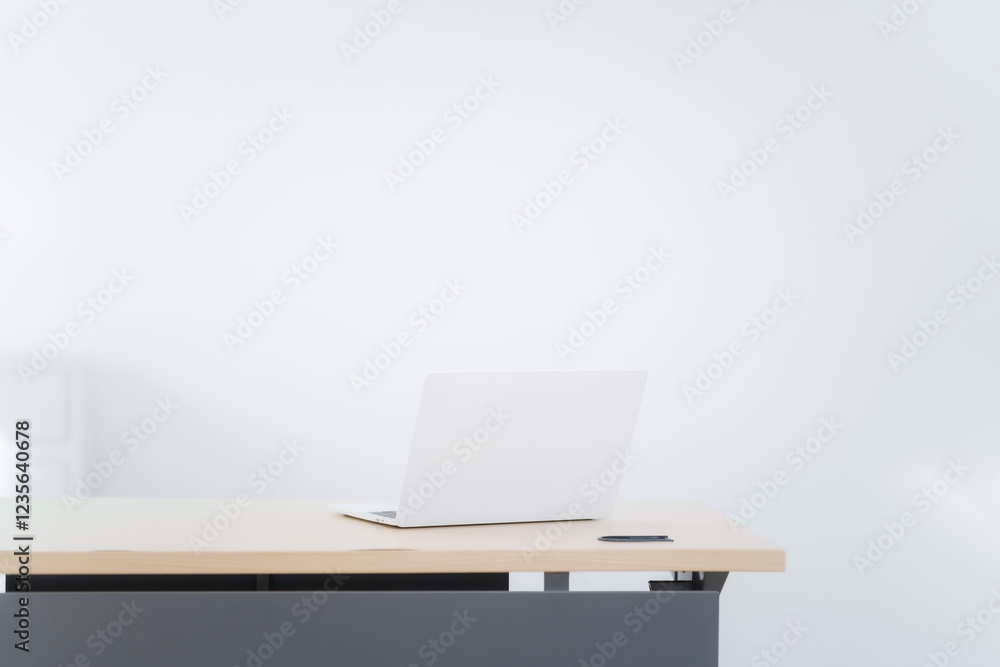 Blank white laptop on blank office desk with blurry white background for display your ads. Blank white laptop on blank office desk with blurry white background for display your ads.