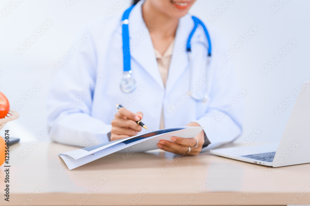 Female Asian nutritionist in lab coat working at desk, offering online consultations with happy smile. dietary nutrients, metabolism, hydration, weight management, meal planning for balanced health. Female Asian nutritionist in lab coat working at desk, offering online consultations with happy smile. dietary nutrients, metabolism, hydration, weight management, meal planning for balanced health.