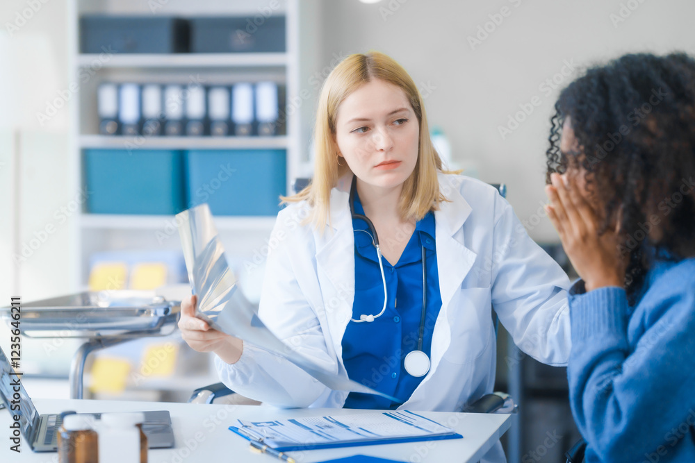 Fototapeta premium A young African American patient consults with a young Russian medical doctor about her immune system and vitamin intake. They discuss patient medical history, vitamin and pill bottles on the desk.