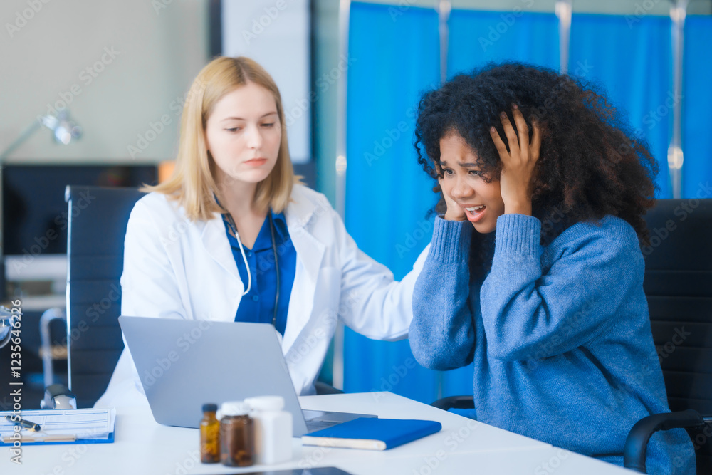 A young African American patient consults with a young Russian medical doctor about her immune system and vitamin intake. They discuss patient medical history, vitamin and pill bottles on the desk. A young African American patient consults with a young Russian medical doctor about her immune system and vitamin intake. They discuss patient medical history, vitamin and pill bottles on the desk.