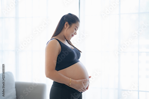 Pregnant asian woman holds hands on belly touching her baby caring about her health Beautiful happy pregnant woman tender mood photo of pregnancy. Free Download Pregnant asian woman holds hands on belly touching her baby caring about her health Beautiful happy pregnant woman tender mood photo of pregnancy. - GFXLoad