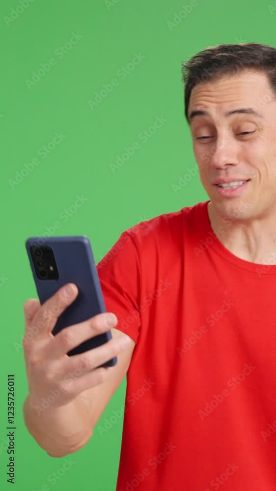 Man in red t shirt having a video call on green screen Man in red t shirt having a video call on green screen