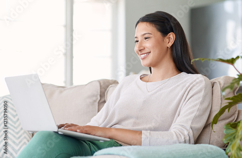 Sofa, happy woman and laptop with connection for search movie, entertainment and film for christmas day. Home, female person and smile with digital for subscription, series check and holiday season photo