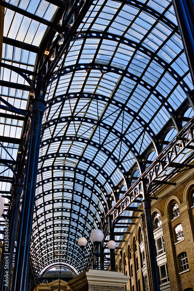 Arched Glass and Metal Roof Structure with Lighting Fixtures in London, UK. Arched Glass and Metal Roof Structure with Lighting Fixtures in London, UK.