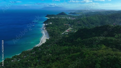 Aninuan Beach in Puerto Galera, Philippines, during sunny day. Sandy white beach with clear Ocean water. Aerial to down flyover shot. photo