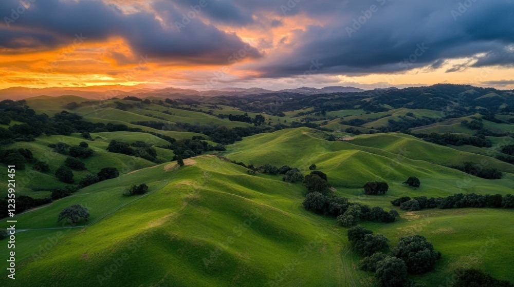 Fototapeta premium Rolling Green Hills Sunset Landscape Dramatic Sky